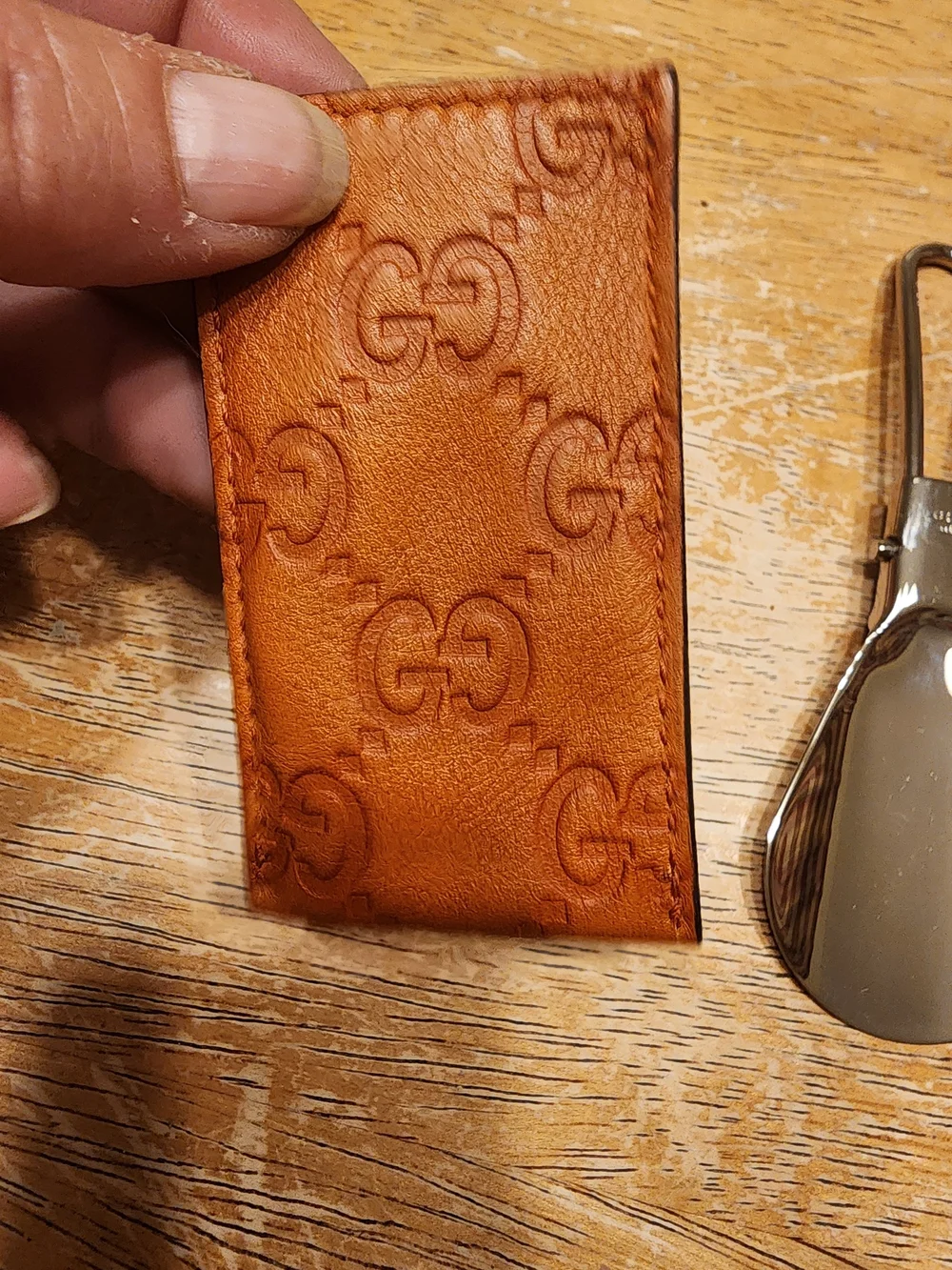vintage Gucci portable metal shoehorn housed in an embossed brown Guccissima GG